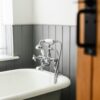 a bathroom with a claw foot tub and a wooden door